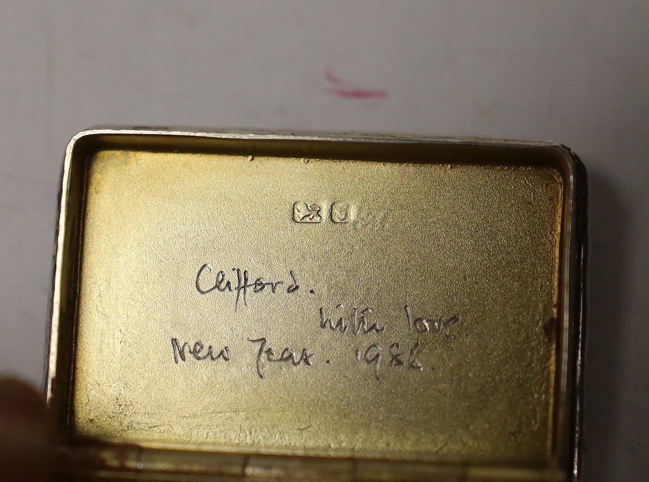 A modern silver snuff box, an Edwardian silver 'envelope' stamp case, a German 925 snuff box and an unusual antique white metal spinning fob seal case?
